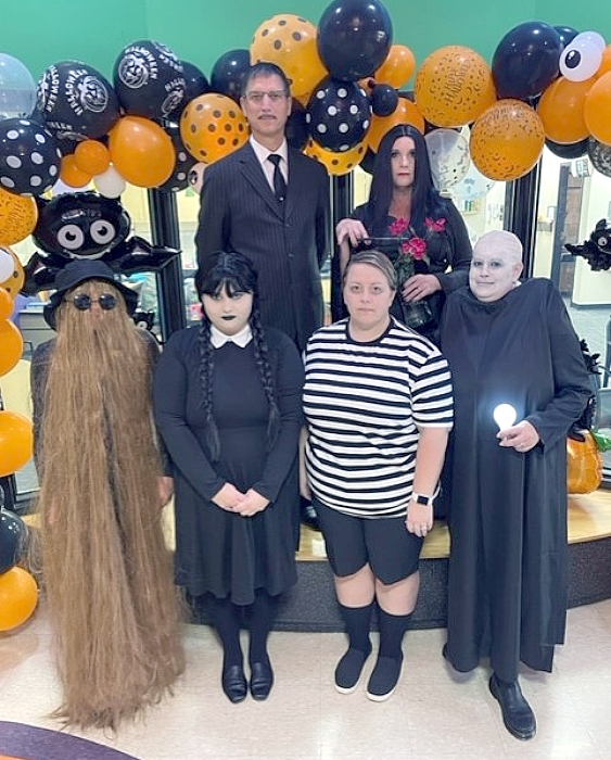 Photo of office staff in Adams Family costumes