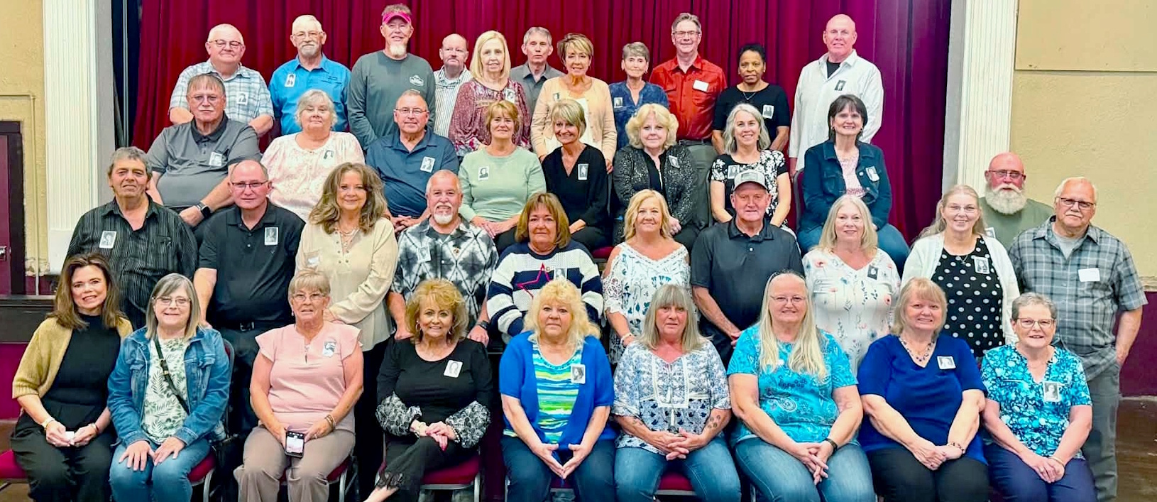 Photo of the Oak Hill High School Class of 1976 taken in 2026 at the Liberty Theater